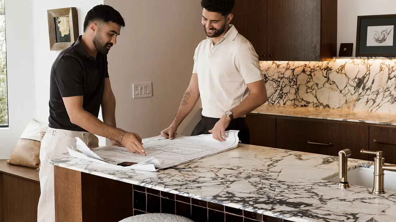 New Edge team reviewing renovation plans in an Austin kitchen